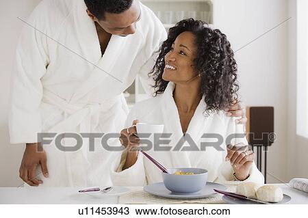 Stock Image - Mid adult couple at breakfast. Fotosearch