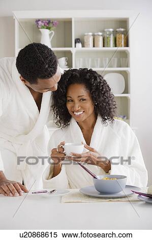 Stock Photography - Mid adult couple at breakfast. Fotosearch