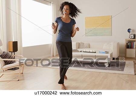 Mid adult woman dancing at home View Large Photo Image Stock Image - Mid adult woman dancing at home. Fotosearch