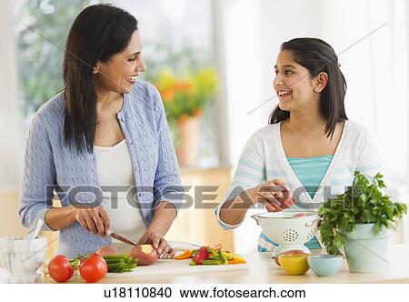 Mother and daughter (12-13) cooking in kitchen View Large Photo Image Stock Image - Mother and daughter (12-13) cooking in kitchen. Fotosearch