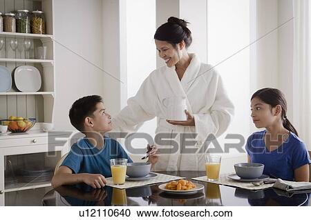 Mother serving breakfast to son and daughter View Large Photo Image Stock Image - Mother serving breakfast to son and daughter. Fotosearch
