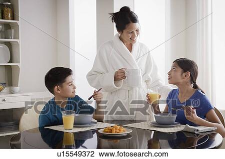 Mother serving breakfast to son and daughter View Large Photo Image Stock Image - Mother serving breakfast to son and daughter. Fotosearch
