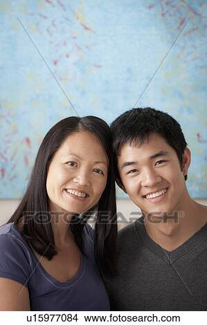 Picture - Mother with adult son posing together. Fotosearch