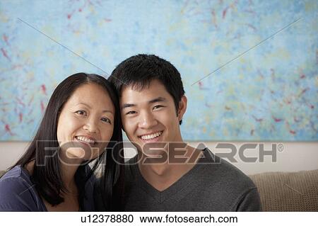 Stock Image - Mother with adult son posing together. Fotosearch