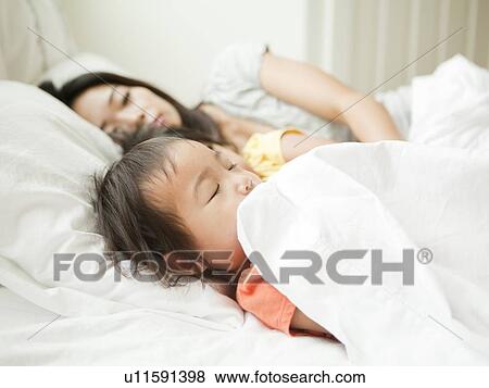 Mother with daughters (2-3, 4-5) sleeping together View Large Photo Image Stock Photo - Mother with daughters (2-3, 4-5) sleeping together. Fotosearch