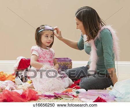 Stock Image - Mother with her daughter (4-5) dressed up as princess. Fotosearch