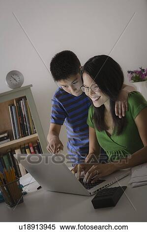 Mother with son using laptop together View Large Photo Image Stock Photography - Mother with son using laptop together. Fotosearch
