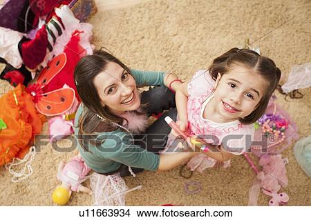 Picture - Overhead view of mother with her daughter (4-5) in fancy dress costume. Fotosearch