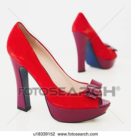 Stock Image - Pair of red high heel open toe shoes on white background. Fotosearch