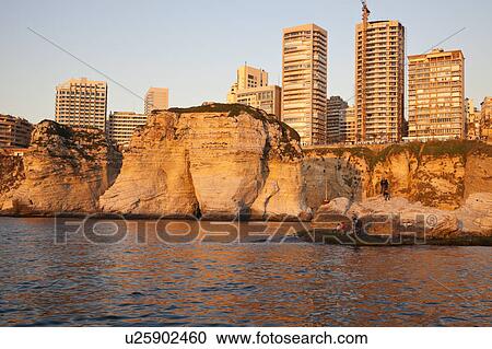 Stock Image - Pigeon Rock and Beirut architecture at sunset. Fotosearch