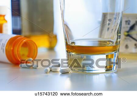 Pills and alcohol, studio shot View Large Photo Image Stock Image - Pills and alcohol, studio shot. Fotosearch