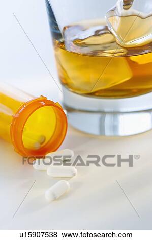 Stock Photo - Pills and alcohol, studio shot. Fotosearch