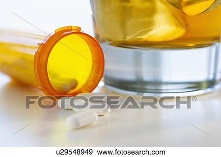 Pills and alcohol, studio shot View Large Photo Image Stock Photo - Pills and alcohol, studio shot. Fotosearch