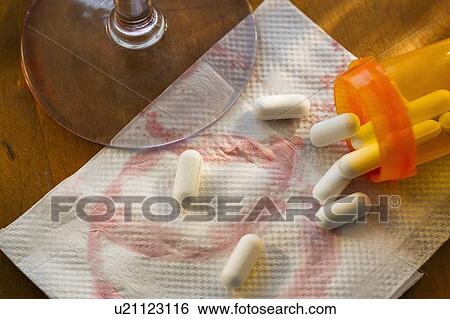 Stock Photograph - Pills spilling on napkin, studio shot. Fotosearch