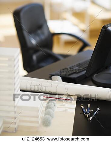 Stock Image - Plans on architect's desk. Fotosearch