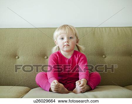 Portrait of baby girl (18-23 months) sitting on sofa View Large Photo Image Picture - Portrait of baby girl (18-23 months) sitting on sofa. Fotosearch