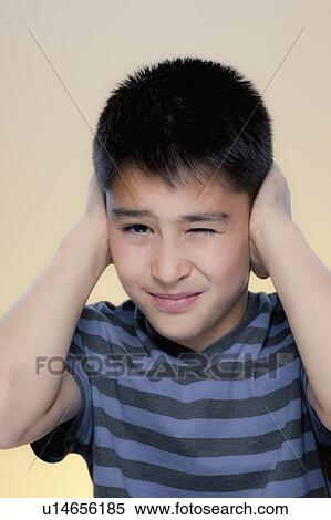 Portrait of boy making displeased expression View Large Photo Image Stock Photography - Portrait of boy making displeased expression. Fotosearch