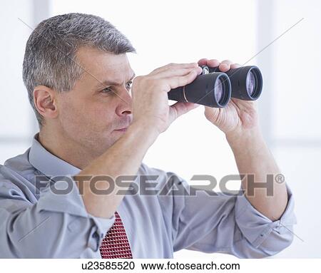 Portrait of businessman holding binoculars View Large Photo Image Stock Image - Portrait of businessman holding binoculars. Fotosearch