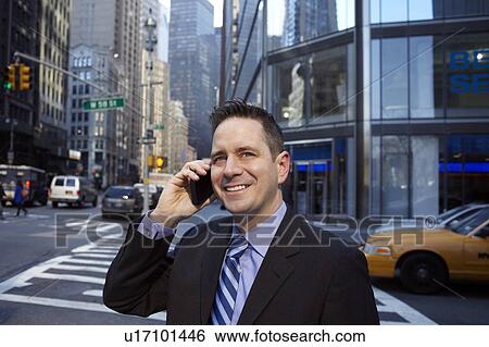 Stock Photograph - Portrait of businessman in city. Fotosearch