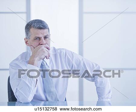 Portrait of businessman sitting at desk View Large Photo Image Stock Photo - Portrait of businessman sitting at desk. Fotosearch