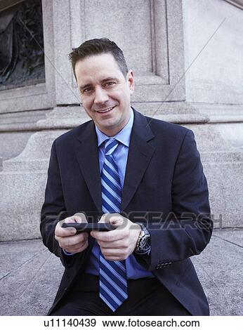 Portrait of businessman with smartphone View Large Photo Image Stock Photo - Portrait of businessman with smartphone. Fotosearch