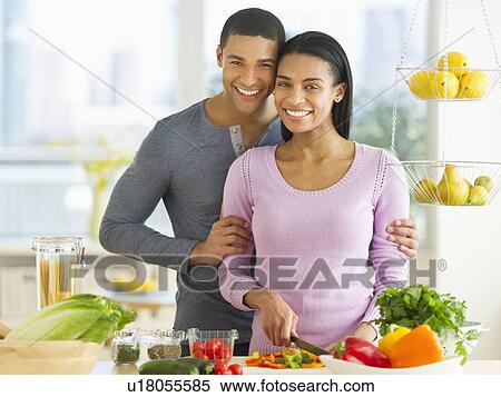 Portrait of couple chopping vegetables in kitchen View Large Photo Image Stock Photography - Portrait of couple chopping vegetables in kitchen. Fotosearch