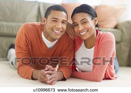 Portrait of couple lying on floor View Large Photo Image Stock Image - Portrait of couple lying on floor. Fotosearch
