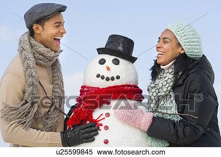 Portrait of couple with snowman View Large Photo Image Stock Photography - Portrait of couple with snowman. Fotosearch