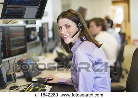 Portrait of female trader at trading desk View Large Photo Image Stock Image - Portrait of female trader at trading desk. Fotosearch