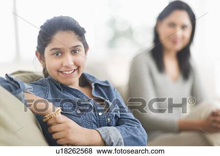 Portrait of girl (12-13), mother in background View Large Photo Image Stock Photo - Portrait of girl (12-13), mother in background. Fotosearch