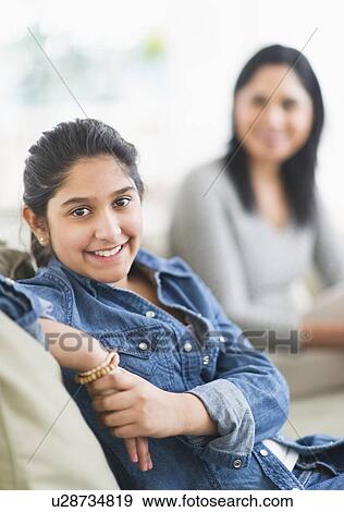 Portrait of girl (12-13), mother in background View Large Photo Image Stock Photo - Portrait of girl (12-13), mother in background. Fotosearch