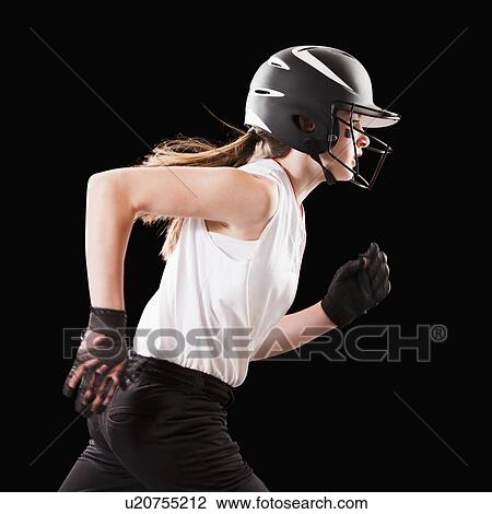Stock Image - Portrait of girl (12-13) plying softball. Fotosearch
