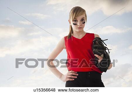 Stock Photo - Portrait of girl (12-13) plying softball. Fotosearch