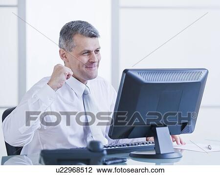 Portrait of happy businessman working at desk View Large Photo Image Stock Image - Portrait of happy businessman working at desk. Fotosearch