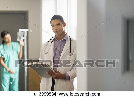 Portrait of male doctor in hallway View Large Photo Image Picture - Portrait of male doctor in hallway. Fotosearch