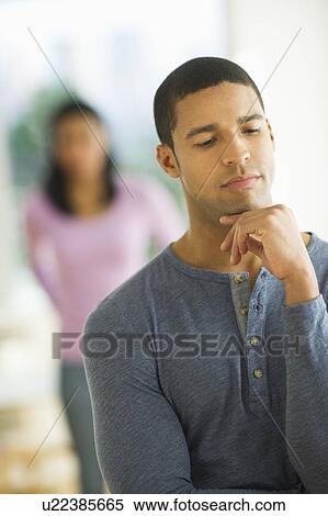 Portrait of man, woman in background View Large Photo Image Stock Photography - Portrait of man, woman in background. Fotosearch