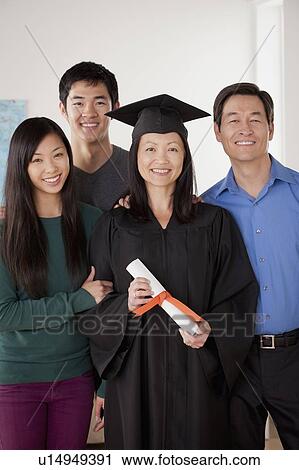 Portrait of mature woman in graduation gown with family View Large Photo Image Stock Image - Portrait of mature woman in graduation gown with family. Fotosearch