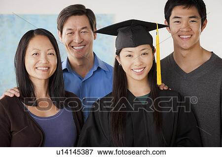 Portrait of mature woman in graduation gown with family View Large Photo Image Stock Photo - Portrait of mature woman in graduation gown with family. Fotosearch