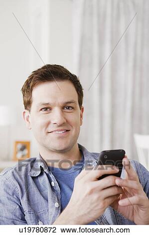 Portrait of mid adult man using mobile phone View Large Photo Image Stock Image - Portrait of mid adult man using mobile phone. Fotosearch
