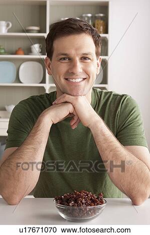 Portrait of mid adult man with bowl of raisins View Large Photo Image Stock Image - Portrait of mid adult man with bowl of raisins. Fotosearch