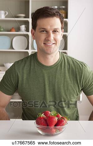 Portrait of mid adult man with bowl of strawberries View Large Photo Image Stock Photography - Portrait of mid adult man with bowl of strawberries. Fotosearch