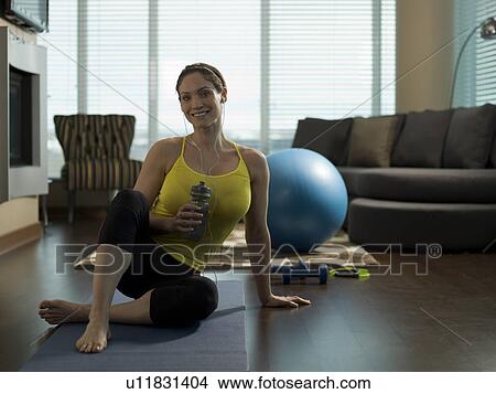 Portrait of mid adult woman exercising at home View Large Photo Image Picture - Portrait of mid adult woman exercising at home. Fotosearch