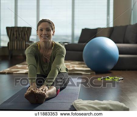 Portrait of mid adult woman exercising at home View Large Photo Image Stock Image - Portrait of mid adult woman exercising at home. Fotosearch