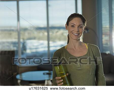 Portrait of mid adult woman exercising at home View Large Photo Image Stock Photography - Portrait of mid adult woman exercising at home. Fotosearch