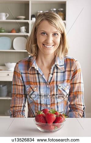 Portrait of mid adult woman with bowl of strawberries View Large Photo Image Picture - Portrait of mid adult woman with bowl of strawberries. Fotosearch