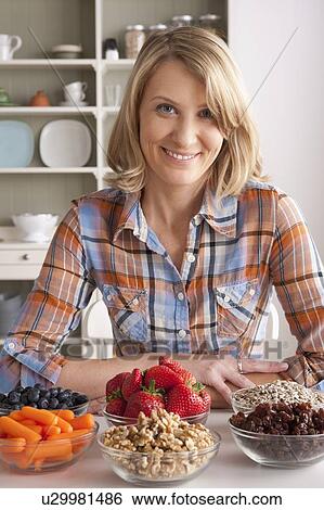 Portrait of mid adult woman with healthy fruits View Large Photo Image Stock Photograph - Portrait of mid adult woman with healthy fruits. Fotosearch