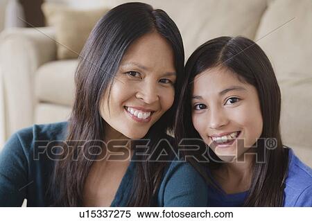Stock Photography - Portrait of mother and daughter smiling. Fotosearch