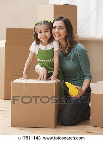 Portrait of mother with daughter (4-5) surrounded by cardboard boxes View Large Photo Image Stock Image - Portrait of mother with daughter (4-5) surrounded by cardboard boxes. Fotosearch