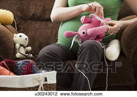 Portrait of pregnant woman preparing stuffed toys for baby View Large Photo Image Stock Image - Portrait of pregnant woman preparing stuffed toys for baby. Fotosearch