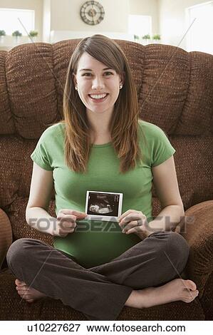 Portrait of pregnant woman showing ultrasonography scan View Large Photo Image Stock Photo - Portrait of pregnant woman showing ultrasonography scan. Fotosearch